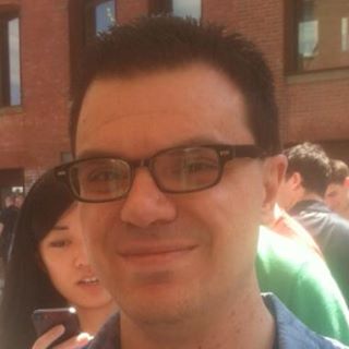 [Photo: Dark-haired caucasian male, mid-thirties, wearing dark-rimmed eyeglasses]